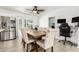 Bright dining area with seating for six, featuring a view to the backyard and modern stainless refrigerator at 699 W Shannon St, Chandler, AZ 85225