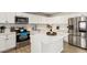 Bright kitchen with white cabinetry, a stainless steel refrigerator, and white countertops at 699 W Shannon St, Chandler, AZ 85225