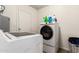 This laundry room features new white appliances and tile floors at 699 W Shannon St, Chandler, AZ 85225