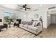 Cozy living room featuring a ceiling fan, comfortable seating, and natural light at 699 W Shannon St, Chandler, AZ 85225