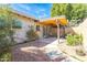 Inviting backyard featuring a covered patio with comfortable seating, surrounded by lush greenery and a serene atmosphere at 8355 E Thomas Rd, Scottsdale, AZ 85251