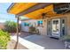 View of a serene backyard with a covered patio, lush landscaping, and outdoor space, perfect for relaxing and entertaining at 8355 E Thomas Rd, Scottsdale, AZ 85251