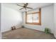 Bedroom with ceiling fan, carpet, and good natural light at 8355 E Thomas Rd, Scottsdale, AZ 85251