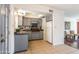 Kitchen with tile flooring, grey cabinetry, and white appliances at 8355 E Thomas Rd, Scottsdale, AZ 85251