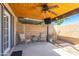 Relaxing covered patio featuring chairs, ceiling fan, and outdoor television, perfect for entertaining or enjoying the outdoors at 8355 E Thomas Rd, Scottsdale, AZ 85251