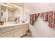 Bathroom with a large mirror, lots of counter space and decorative floral wallpaper at 9090 N 86Th Pl, Scottsdale, AZ 85258