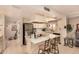 Well-lit kitchen boasting white cabinetry, stainless appliances, and a central island with barstool seating at 9090 N 86Th Pl, Scottsdale, AZ 85258