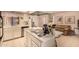 Fully equipped kitchen with stainless cooktop on island, and white cabinets at 9090 N 86Th Pl, Scottsdale, AZ 85258