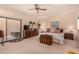 Spacious main bedroom with a ceiling fan and sliding glass doors leading to the outside spa at 9090 N 86Th Pl, Scottsdale, AZ 85258