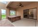 Relaxing covered patio with hot tub and a decorative brick walkway to the yard at 9090 N 86Th Pl, Scottsdale, AZ 85258