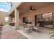 Inviting covered patio with ceiling fan, dining set, and views of the backyard at 9090 N 86Th Pl, Scottsdale, AZ 85258