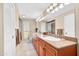 Large bathroom featuring double sinks, granite counters, and wood cabinetry at 9309 W Briarwood Cir, Sun City, AZ 85351