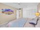 Relaxing bedroom featuring a queen bed, ensuite, soft carpet, and neutral decor at 9309 W Briarwood Cir, Sun City, AZ 85351