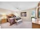 Bright bedroom with a carved wood bed frame and large windows at 9309 W Briarwood Cir, Sun City, AZ 85351