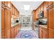 Well-equipped kitchen with wooden cabinets and stainless-steel appliances, leading to the dining area at 9309 W Briarwood Cir, Sun City, AZ 85351