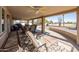 Relaxing covered patio with outdoor seating and views of the lush green golf course at 9309 W Briarwood Cir, Sun City, AZ 85351