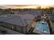 Luxury home's aerial view shows pool, patio, landscaping, and community, against a mountain backdrop at 9370 E Wethersfield Rd, Scottsdale, AZ 85260