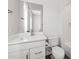 Bright bathroom featuring a white vanity with chrome hardware and a matching toilet at 9370 E Wethersfield Rd, Scottsdale, AZ 85260