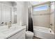 Bathroom featuring modern white and grey design elements with a shower-tub combo and window at 9370 E Wethersfield Rd, Scottsdale, AZ 85260