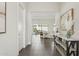 Inviting entryway with tile flooring, stylish console table, and artwork leading to the open-concept living space at 9370 E Wethersfield Rd, Scottsdale, AZ 85260