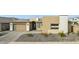 Contemporary home featuring a well-manicured front yard with desert landscaping, a modern garage door, and neutral color palette at 9370 E Wethersfield Rd, Scottsdale, AZ 85260