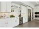 Elegant kitchen includes stainless steel appliances, a wine cooler, and white cabinetry with modern hardware at 9370 E Wethersfield Rd, Scottsdale, AZ 85260