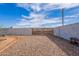 Fenced backyard with gravel and a large wooden gate at 99 W Circle Dr, Florence, AZ 85132