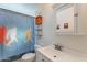 Bathroom featuring vanity with white countertop, novelty shower curtain, and storage at 99 W Circle Dr, Florence, AZ 85132