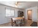 Cozy dining room featuring neutral tile floors, a ceiling fan, and natural lighting at 99 W Circle Dr, Florence, AZ 85132