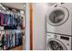 Laundry area features a stacked washer and dryer and storage shelves at 99 W Circle Dr, Florence, AZ 85132