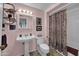 Bathroom features a shower/bath combo, sink, toilet, and a light color scheme at 10019 W Shasta Dr, Sun City, AZ 85351