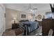 This bedroom features a queen bed, ceiling fan, wood floors, and a neutral color scheme at 10019 W Shasta Dr, Sun City, AZ 85351