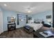 This bedroom features a queen bed, wood floors, and an adjacent en suite bath at 10019 W Shasta Dr, Sun City, AZ 85351