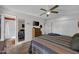 This bedroom features a queen bed, wood floors, walk in closet and an en suite bath at 10019 W Shasta Dr, Sun City, AZ 85351