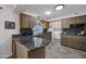 Well-lit kitchen featuring granite countertops, wooden cabinetry, tile floors, and modern appliances at 10019 W Shasta Dr, Sun City, AZ 85351