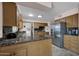 Bright kitchen with a stainless steel refrigerator, granite counters, and ample cabinet space at 10019 W Shasta Dr, Sun City, AZ 85351