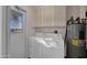 Laundry room features a standard washer and dryer and built-in storage at 10019 W Shasta Dr, Sun City, AZ 85351