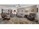 Inviting living room with ceiling fan, comfortable seating, and a view into the dining area at 10019 W Shasta Dr, Sun City, AZ 85351