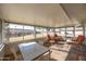 This sun room features tile floors and multiple glass windows overlooking the back yard at 10019 W Shasta Dr, Sun City, AZ 85351