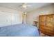 Bedroom featuring wood-look floors, a ceiling fan, and built in storage at 10407 W Mission Ln, Sun City, AZ 85351