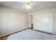 Bedroom with a ceiling fan, neutral walls, wood-look flooring, and a closet with sliding doors at 10407 W Mission Ln, Sun City, AZ 85351