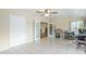 Bonus room with large tile floors, neutral paint, ceiling fan, and glass french doors at 10407 W Mission Ln, Sun City, AZ 85351