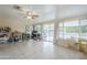 Bonus room featuring tile flooring, large windows, ceiling fan, and a view to outdoor living at 10407 W Mission Ln, Sun City, AZ 85351