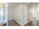 Hallway featuring a bench, white doors, neutral walls, and wood-look flooring at 10407 W Mission Ln, Sun City, AZ 85351