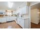 Bright kitchen featuring white cabinetry, granite countertops, and stainless appliances at 10407 W Mission Ln, Sun City, AZ 85351