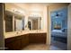 Bright bathroom features dual sinks and a view of the adjacent bedroom with a picturesque outdoor view at 10410 N Cave Creek Rd # 2007, Phoenix, AZ 85020