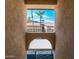 Framed view of community buildings with red tile roofs and palm trees under a bright blue, partly cloudy sky at 10410 N Cave Creek Rd # 2007, Phoenix, AZ 85020