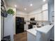 Updated kitchen boasts white cabinetry, black appliances, and a clean, modern design with sleek countertops at 10410 N Cave Creek Rd # 2007, Phoenix, AZ 85020