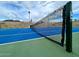 Close-up of the net on a community tennis court surrounded by a fence and mountain views at 10410 N Cave Creek Rd # 2007, Phoenix, AZ 85020