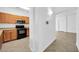 Well-equipped kitchen area with microwave and wood cabinetry, and view of hallway at 110 N 66Th Ave, Phoenix, AZ 85043